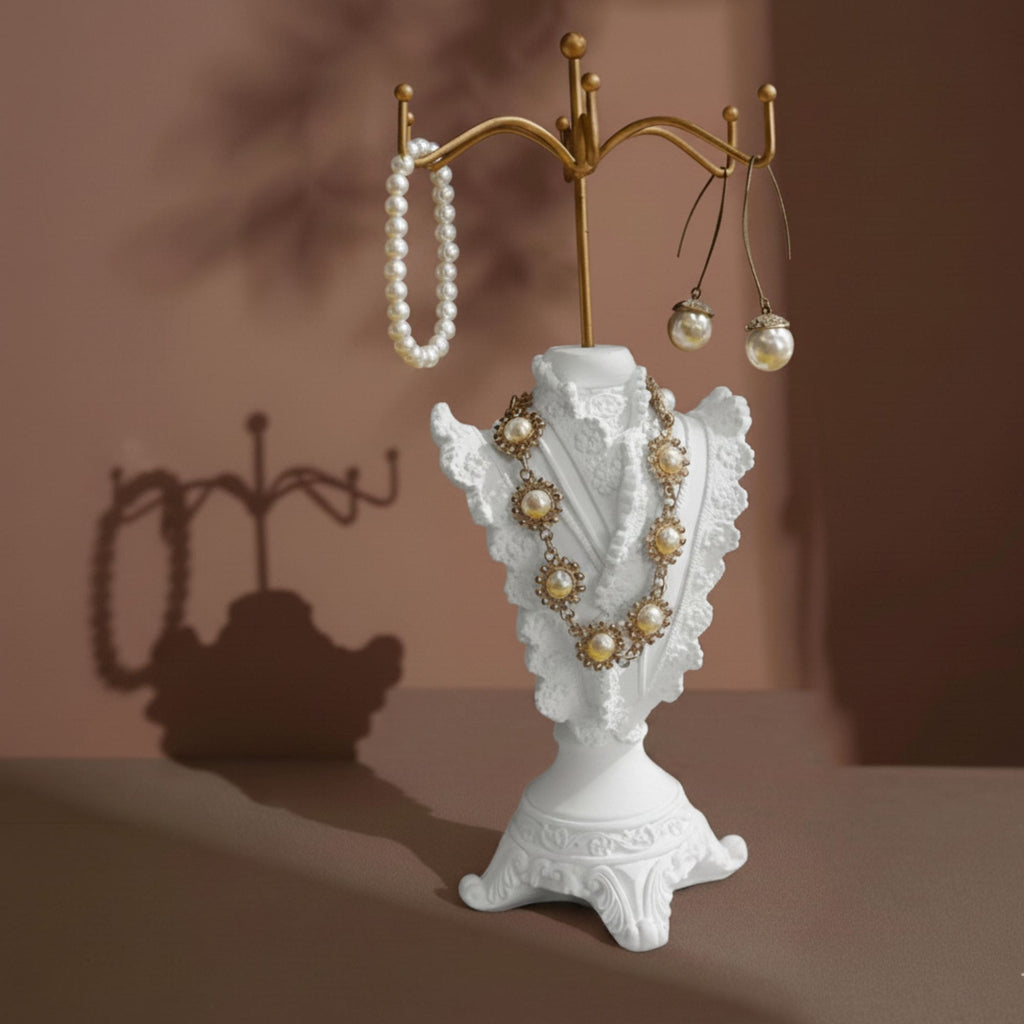 Ivory dress-form jewelry display stand with pearl necklace and earrings on a vanity