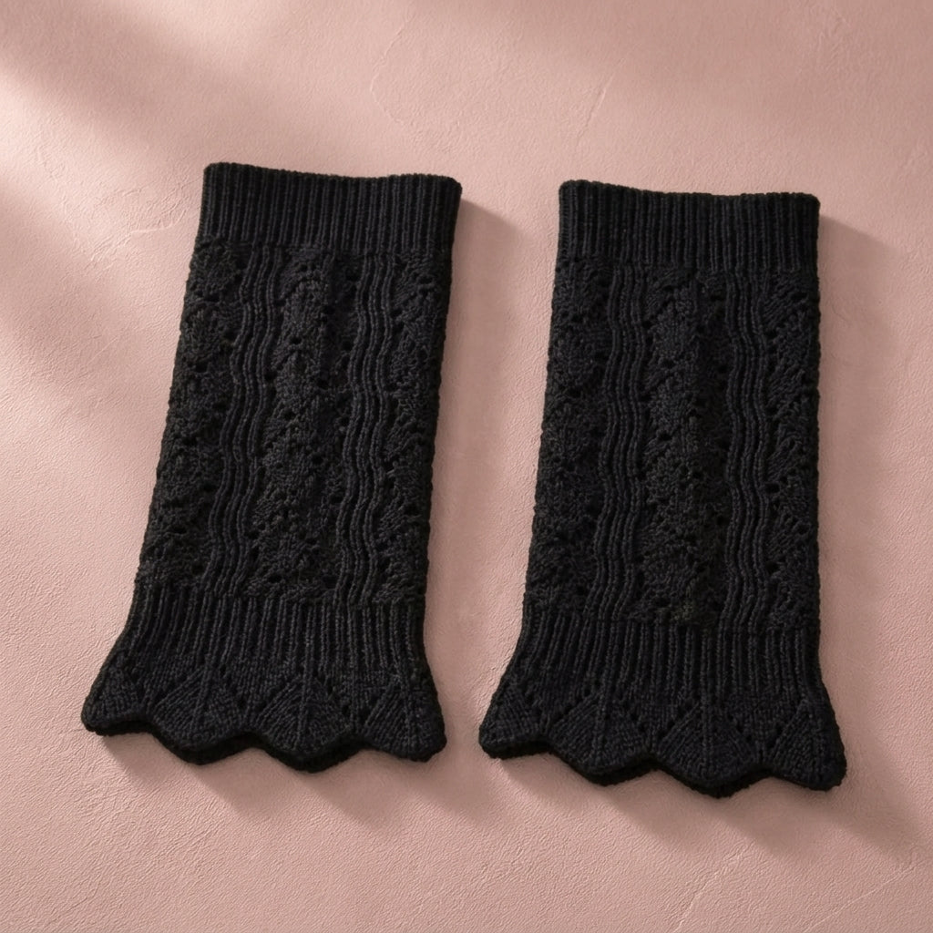 Black pointelle knit boot cuffs, pair flat lay