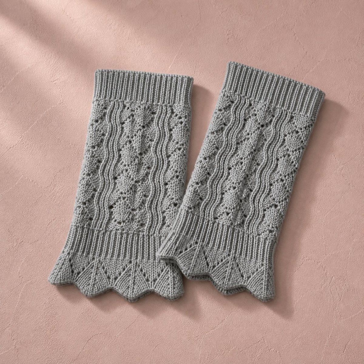 Light gray pointelle knit boot cuffs, pair flat lay