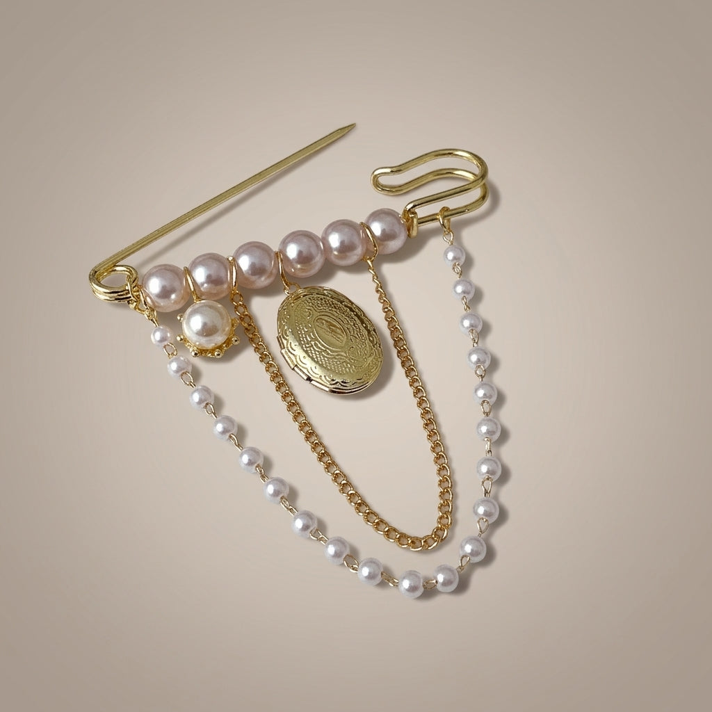 Pearl locket brooch shown with the safety pin open, showing how it fastens