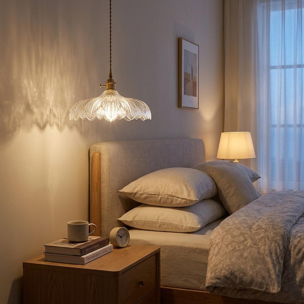 Clear ribbed glass pendant light, correctly scaled at 25-30 cm, hanging beside a bed above a wooden nightstand