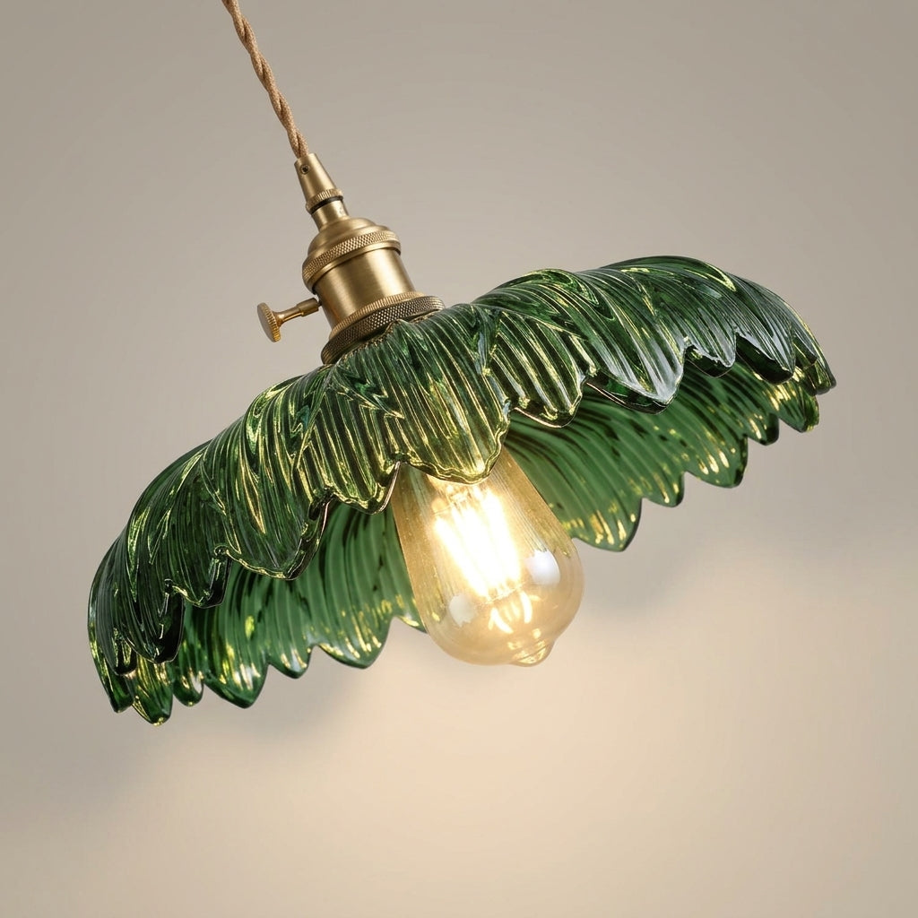 Close-up detail of the emerald ribbed glass shade showing the fluted texture and brass socket hardware