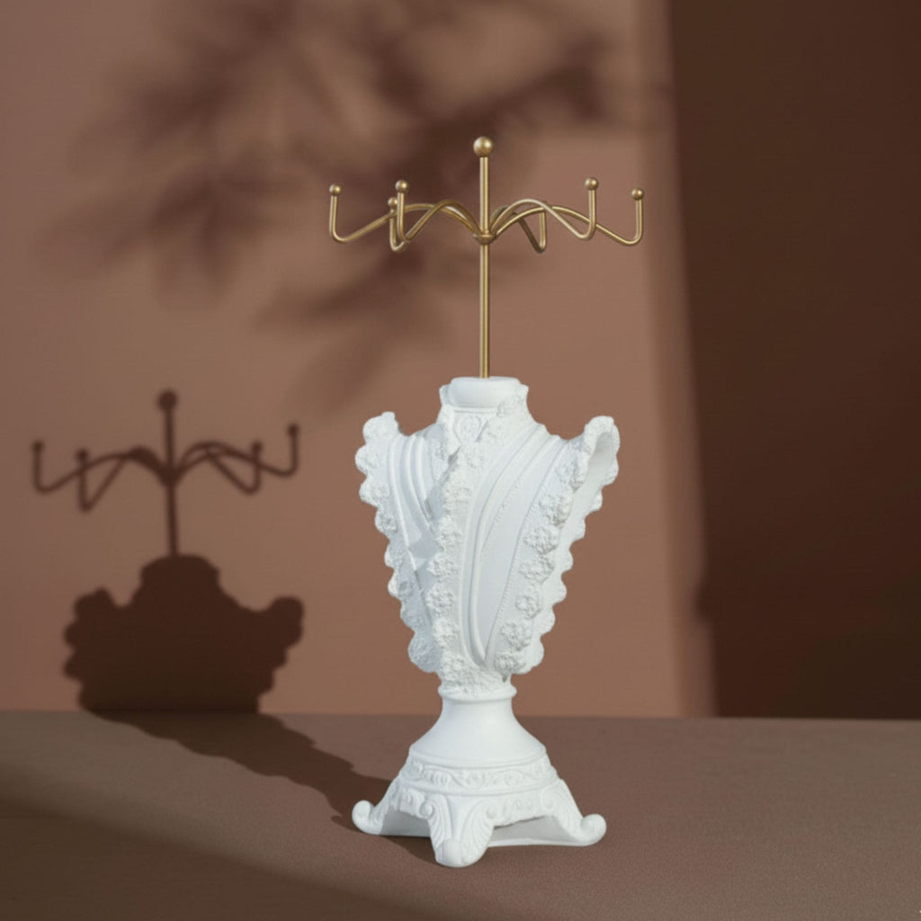 Close-up of an ivory lace-trimmed jewelry stand displaying pearl jewelry