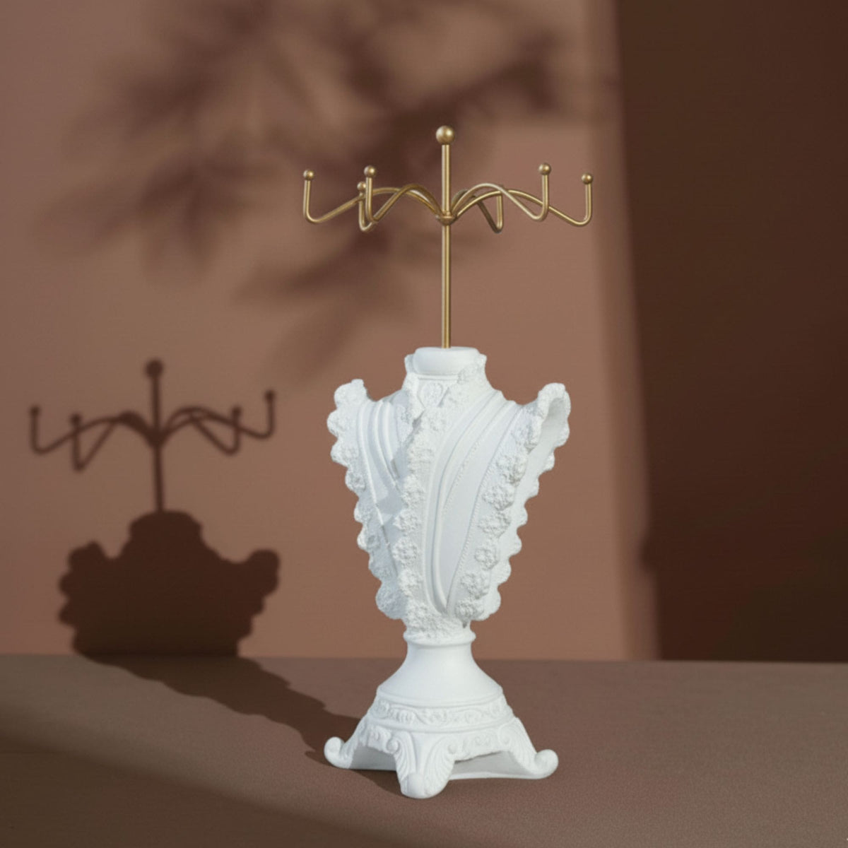 Close-up of an ivory lace-trimmed jewelry stand displaying pearl jewelry